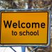Yellow sign with Welcome to School