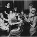 Women of a previous generation sitting around a table during a radio show